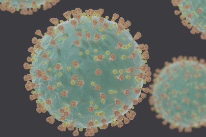 Microscopic 3D rendering of the coronavirus SARS-CoV-2, showing its spherical structure with spike proteins.